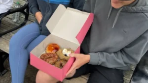 Fresh classic glazed and frosted donuts at Bob's Donut & Pastry Shop on a San Francisco tasting tour